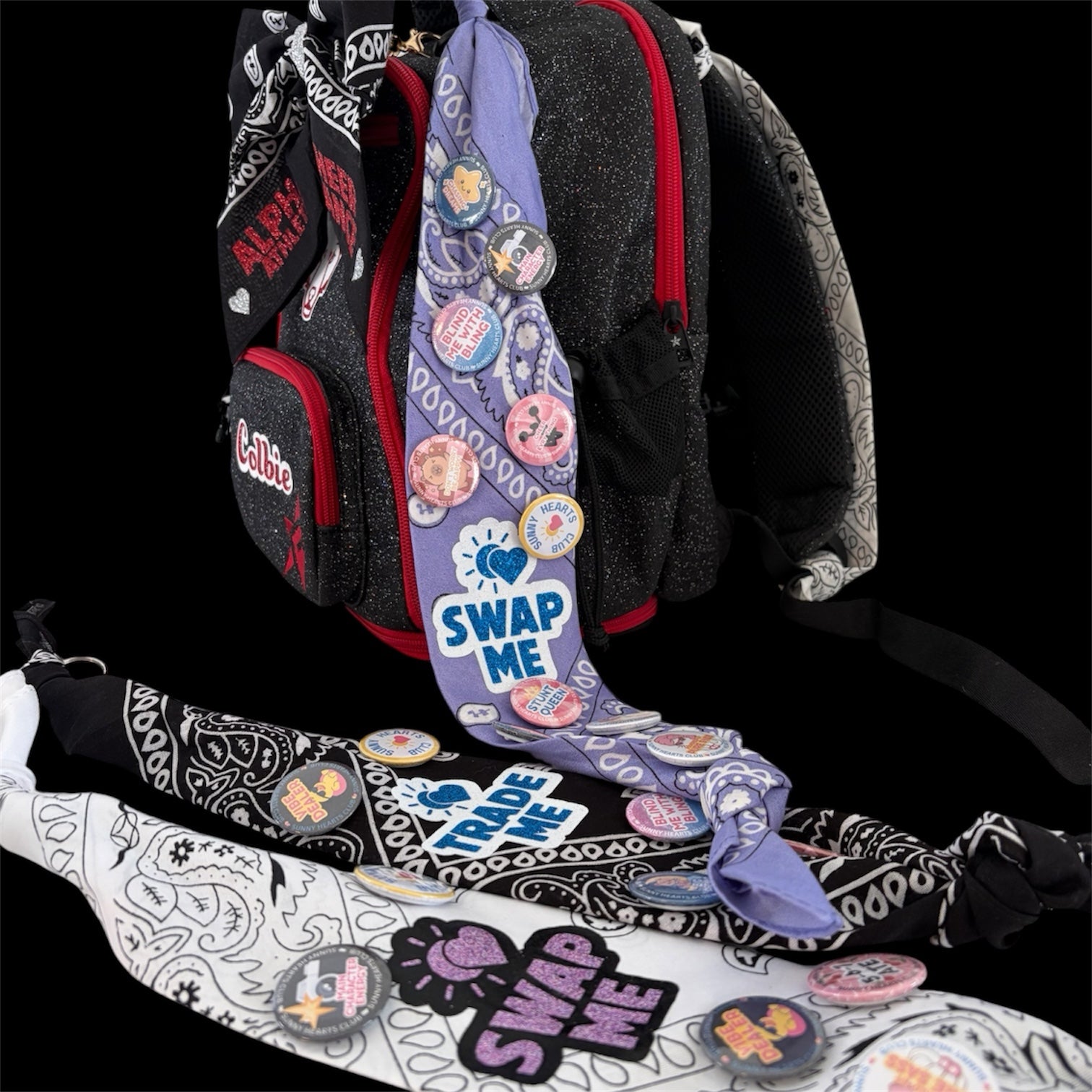 Sunny Hearts Club backpack accessory set featuring black, white, and lilac bandana ribbons decorated with cheer pins.