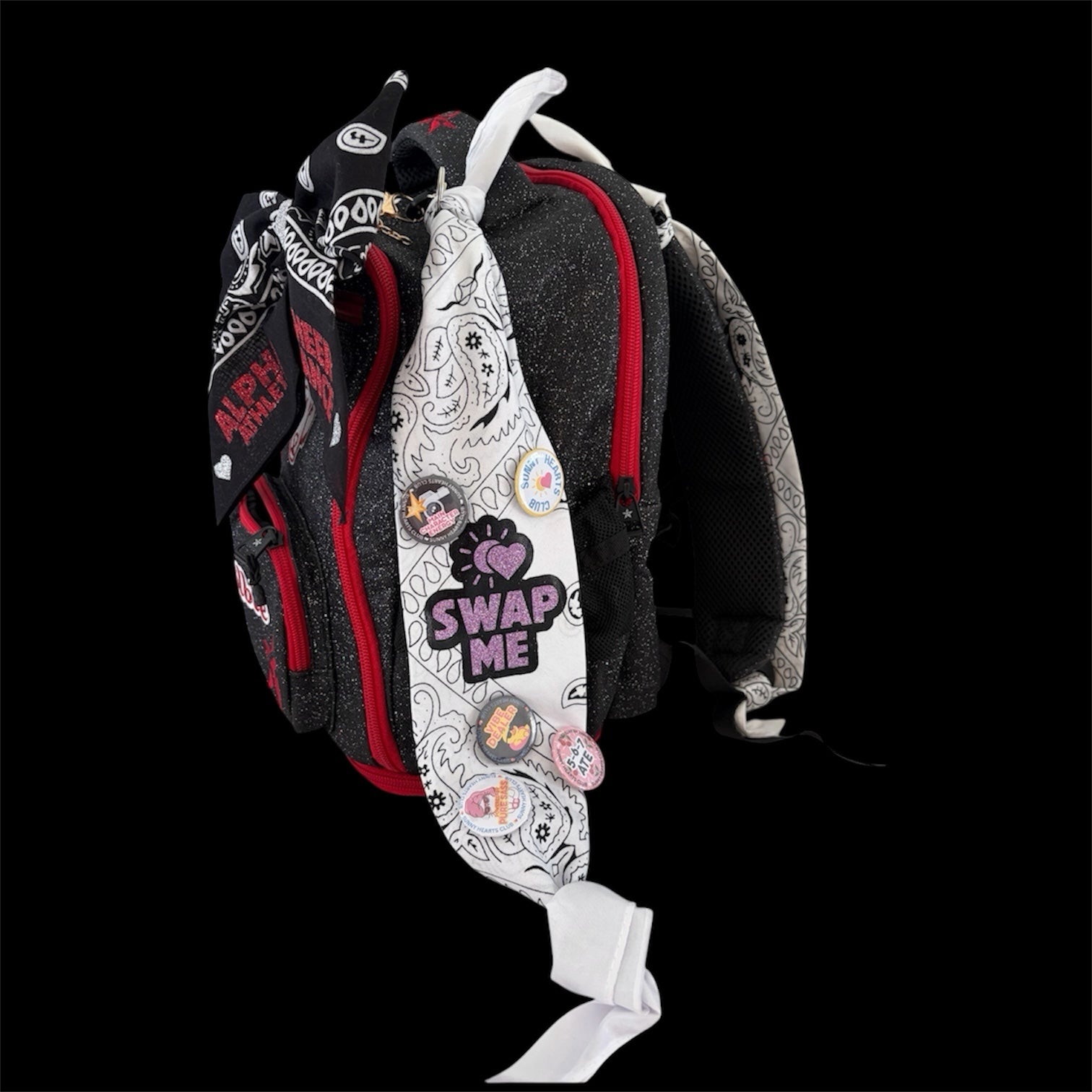 Sunny Hearts Club backpack accessory set featuring black and white bandana ribbons decorated with cheer pins.