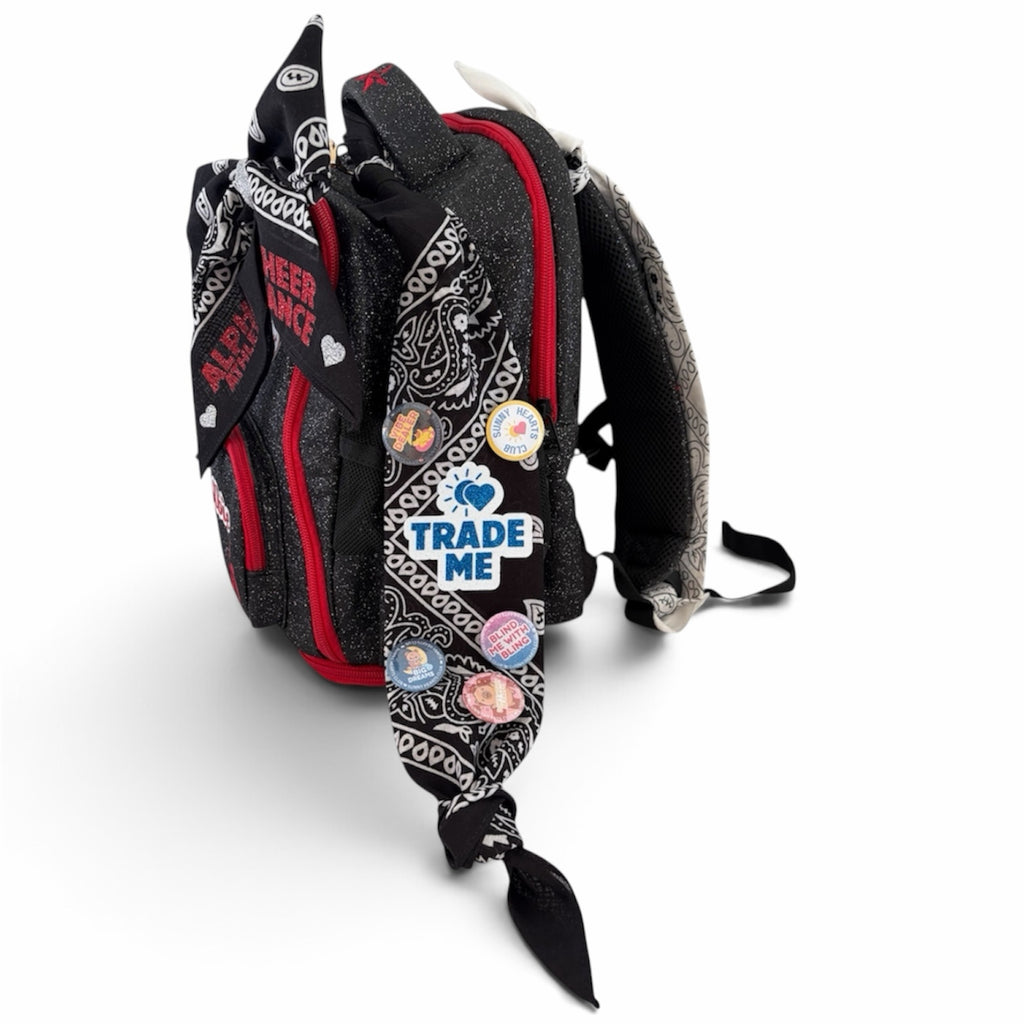 Sunny Hearts Club backpack featuring black and white bandana ribbons decorated with colourful cheer trading pins